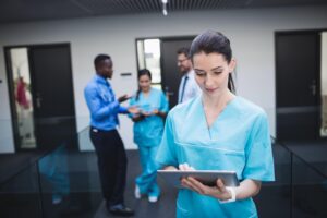 Smiling nurse reviewing her nursing career goals for 2025